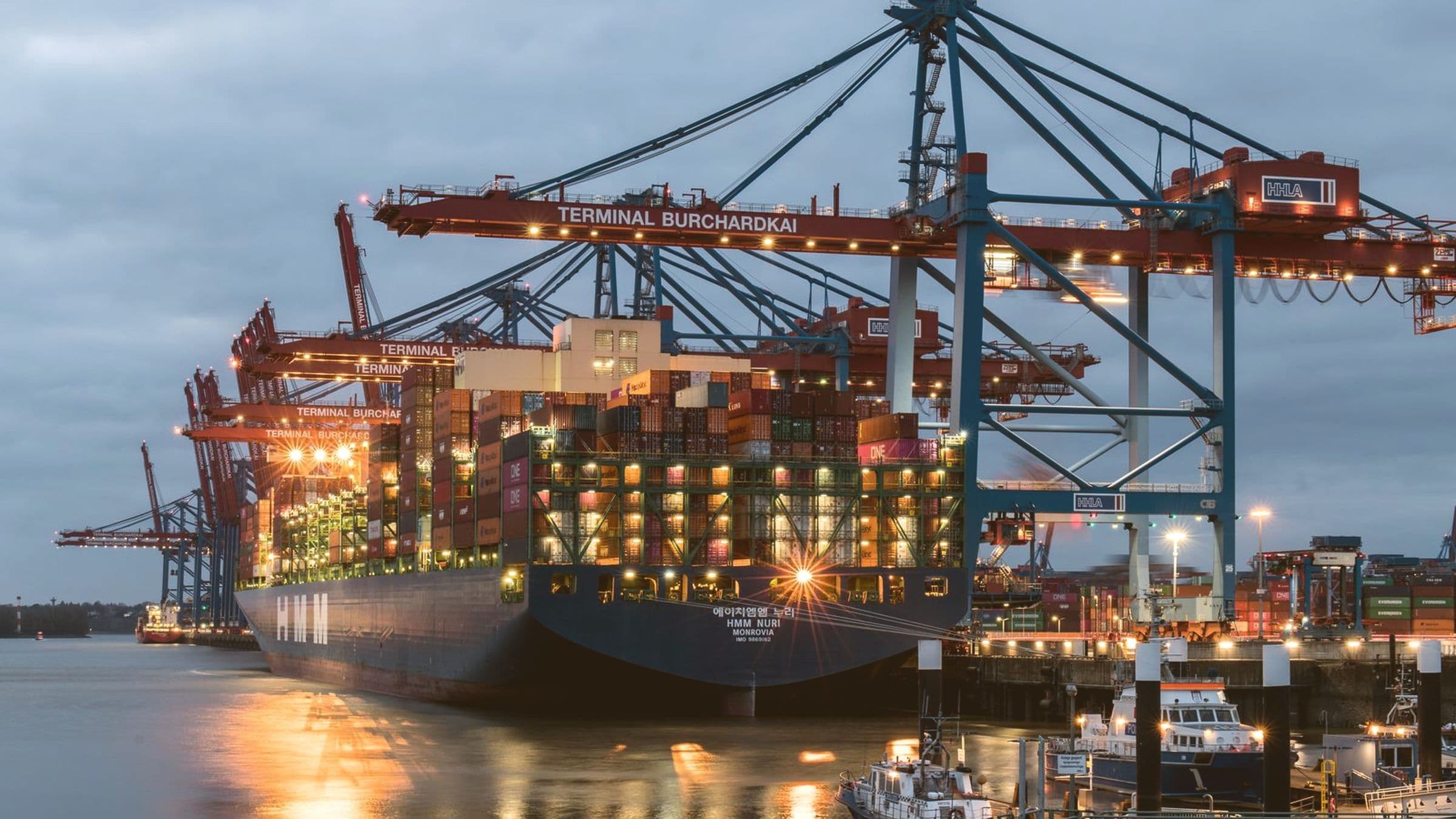 Container vessel alongside a terminal berth at dusk